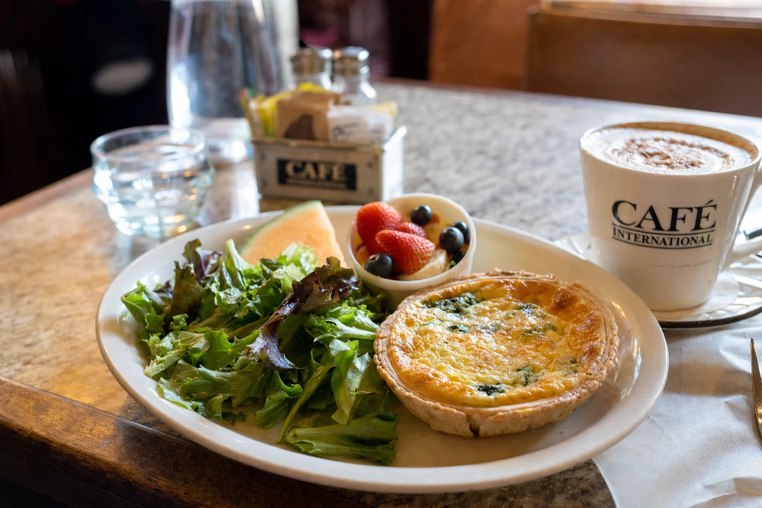A breakfast or brunch plate at Cafe International in Helen, Georgia showcases the continental cafe style cuisine offered at this popular eatery. The dish features fresh ingredients plated with attention to presentation. Coffee or espresso beverages accompany the food, served in ceramic cups. The meal represents the European inspired menu that draws visitors to this Helen cafe throughout morning and afternoon hours. Natural light from the cafe windows illuminates the food, highlighting colors and textures of the ingredients. The presentation reflects the cafe's approach to accessible yet quality focused dining in the heart of Helen's tourist district, where visitors seek both quick bites and leisurely meals during their exploration of Georgia's alpine village.