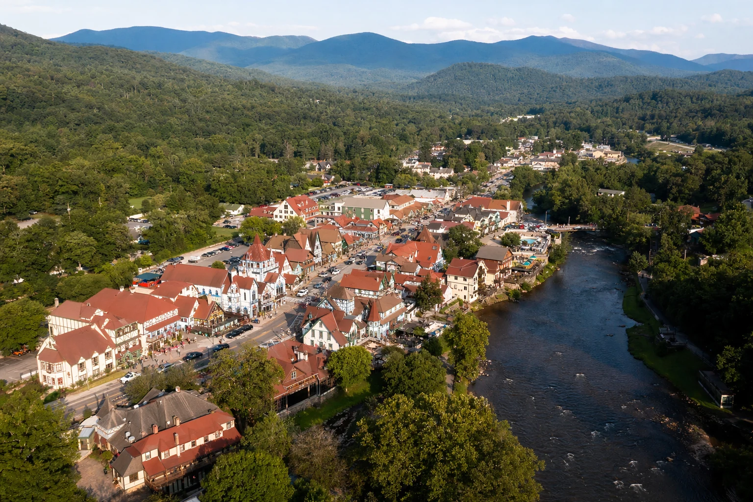 Aerial view of Helen's Alpine-style rooftops beside the Chattahoochee River, with the Blue Ridge Mountains behind